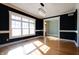 Bright dining room with hardwood floors, large windows, and view of entryway at 7290 Lockford Walk N, Avon, IN 46123