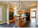 Well-equipped kitchen with wood cabinets, granite countertops, and island at 7290 Lockford Walk N, Avon, IN 46123