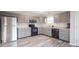 Gray cabinets, stainless steel appliances, and wood-look floors at 8391 Inland Dr, Avon, IN 46123