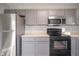 Modern kitchen with stainless steel appliances and gray cabinets at 8391 Inland Dr, Avon, IN 46123