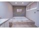 Soaking tub with tile surround and accent wall at 1127 Grant Cir, Cicero, IN 46034