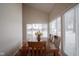 Sun-filled dining area with a wooden table and access to backyard at 1127 Grant Cir, Cicero, IN 46034