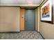 Apartment hallway with a grey door and artwork at 429 N Pennsylvania N St # 804, Indianapolis, IN 46204