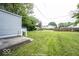 View of backyard with shed and neighboring house at 1519 E Mills Ave, Indianapolis, IN 46227