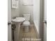 Clean bathroom with pedestal sink, toilet and bathtub at 1519 E Mills Ave, Indianapolis, IN 46227