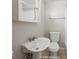Simple bathroom featuring a pedestal sink, toilet, and bathtub at 1519 E Mills Ave, Indianapolis, IN 46227
