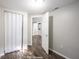 Bedroom with wood-look floors and access to other rooms at 1519 E Mills Ave, Indianapolis, IN 46227