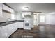 Modern kitchen with white cabinets and dark wood floors at 1519 E Mills Ave, Indianapolis, IN 46227
