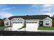 Gray three-car garage home with stone accents and landscaping at 1633 Clover Crossing Dr, Greenfield, IN 46140
