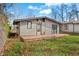 Tan house with wooden deck, surrounded by a yard with autumn leaves at 240 Tuck A Way Ridge Dr, Nashville, IN 47448
