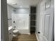 Basement bathroom with a tub, shower, and shelving at 706 W Franklin St, Thorntown, IN 46071