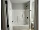 Clean bathroom with white tub/shower and black fixtures at 706 W Franklin St, Thorntown, IN 46071