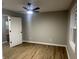 Well-lit bedroom with wood-look floors and door to bathroom at 706 W Franklin St, Thorntown, IN 46071