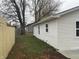 Side view of house showing white siding, new gutters, and a wood fence at 706 W Franklin St, Thorntown, IN 46071