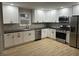 Modern kitchen with white shaker cabinets, stainless steel appliances, and wood countertops at 706 W Franklin St, Thorntown, IN 46071