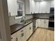 Modern kitchen with white cabinets, stainless steel appliances, and dark wood countertops at 706 W Franklin St, Thorntown, IN 46071