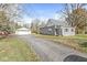 Gray house with attached garage and a long driveway at 8240 Shelbyville Rd, Indianapolis, IN 46259