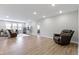Open concept basement featuring a cozy seating area and hardwood flooring at 325 Milltown Dr, Pendleton, IN 46064