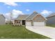 Brick ranch home with 2-car garage and landscaped lawn at 325 Milltown Dr, Pendleton, IN 46064