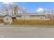 Tan house with a wooden fence and landscaping at 802 N Tuxedo St, Indianapolis, IN 46201