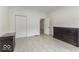 Bedroom with hardwood floors, dark dresser, and white walls at 907 S East St, Indianapolis, IN 46225