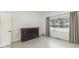 Bedroom with hardwood floors, large window, and dresser at 907 S East St, Indianapolis, IN 46225