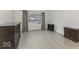 Bedroom with hardwood floors, large windows, and two dressers at 907 S East St, Indianapolis, IN 46225