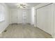 Bedroom with hardwood floors, white walls, and ceiling fan at 907 S East St, Indianapolis, IN 46225
