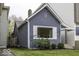 Side view of a charming blue bungalow with landscaping at 907 S East St, Indianapolis, IN 46225