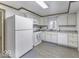 Efficient kitchen featuring white cabinets and appliances at 907 S East St, Indianapolis, IN 46225