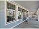 Inviting front porch with grey siding and double windows at 1669 E Greyhawk Way, Greenfield, IN 46140