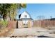 White barn-style home with wooden fence and gated backyard access at 3840 Broadway St, Indianapolis, IN 46205