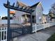 Two-story house with a pergola and gate, plus a white picket fence at 803 E 21St St, Anderson, IN 46016