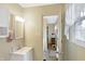 Clean bathroom with a vanity, mirror, and access to the laundry room at 809 W Mill St, Danville, IN 46122