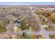 An aerial view of a house situated on a tree-lined street in a residential area at 10592 Lakeshore E Dr, Carmel, IN 46033