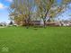 Large backyard with spacious deck and fire pit area at 230 N Knightstown Rd, Shelbyville, IN 46176