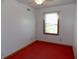 Small bedroom with a window and red carpet at 3022 N Alaska Rd, Cloverdale, IN 46120