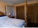 Bedroom with wooden post bed, window, and double closets at 3022 N Alaska Rd, Cloverdale, IN 46120