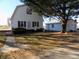 White barn-style home with detached garage and landscaped yard at 3022 N Alaska Rd, Cloverdale, IN 46120