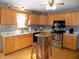 Galley kitchen with wood cabinets, stainless steel appliances, and hardwood floors at 3022 N Alaska Rd, Cloverdale, IN 46120