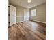 Well-lit bedroom with double doors and wood-look floors at 3270 Acacia Dr, Indianapolis, IN 46214