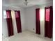 Bedroom with maroon and white curtains at 4025 N Campbell Ave, Indianapolis, IN 46226