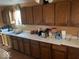 Kitchen with wood cabinets and white counters at 4025 N Campbell Ave, Indianapolis, IN 46226