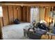 Unfinished storage room with wooden walls and carpeted floor at 4025 N Campbell Ave, Indianapolis, IN 46226