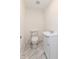 Clean bathroom with toilet and pedestal sink at 6015 S State Road 75, Coatesville, IN 46121