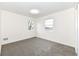 Bright bedroom with neutral carpeting and two large windows at 6015 S State Road 75, Coatesville, IN 46121