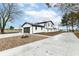 Modern home exterior with a large driveway and fire pit at 6015 S State Road 75, Coatesville, IN 46121