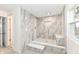 Walk-in shower with marble tile and built-in seat at 6015 S State Road 75, Coatesville, IN 46121