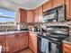 Kitchen with stove, microwave, and black appliances at 7532 Gold Rush Ct, Camby, IN 46113