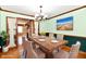 Virtually staged dining room with a wood table and hardwood floors at 7912 E St Joseph St, Indianapolis, IN 46219